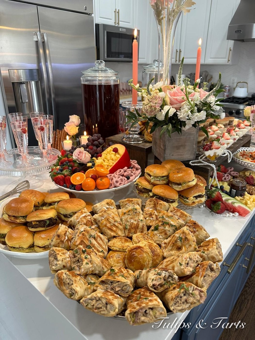 Kitchen island grazing spread with rolls, sliders and florals
