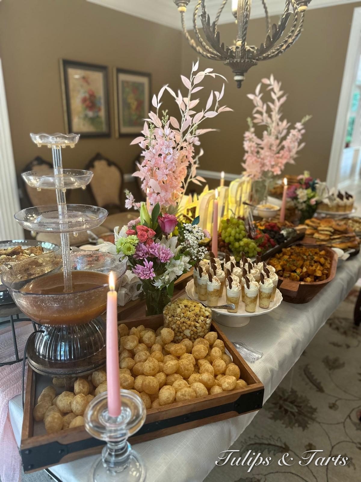 Styled dessert table with chocolate fountain and florals
