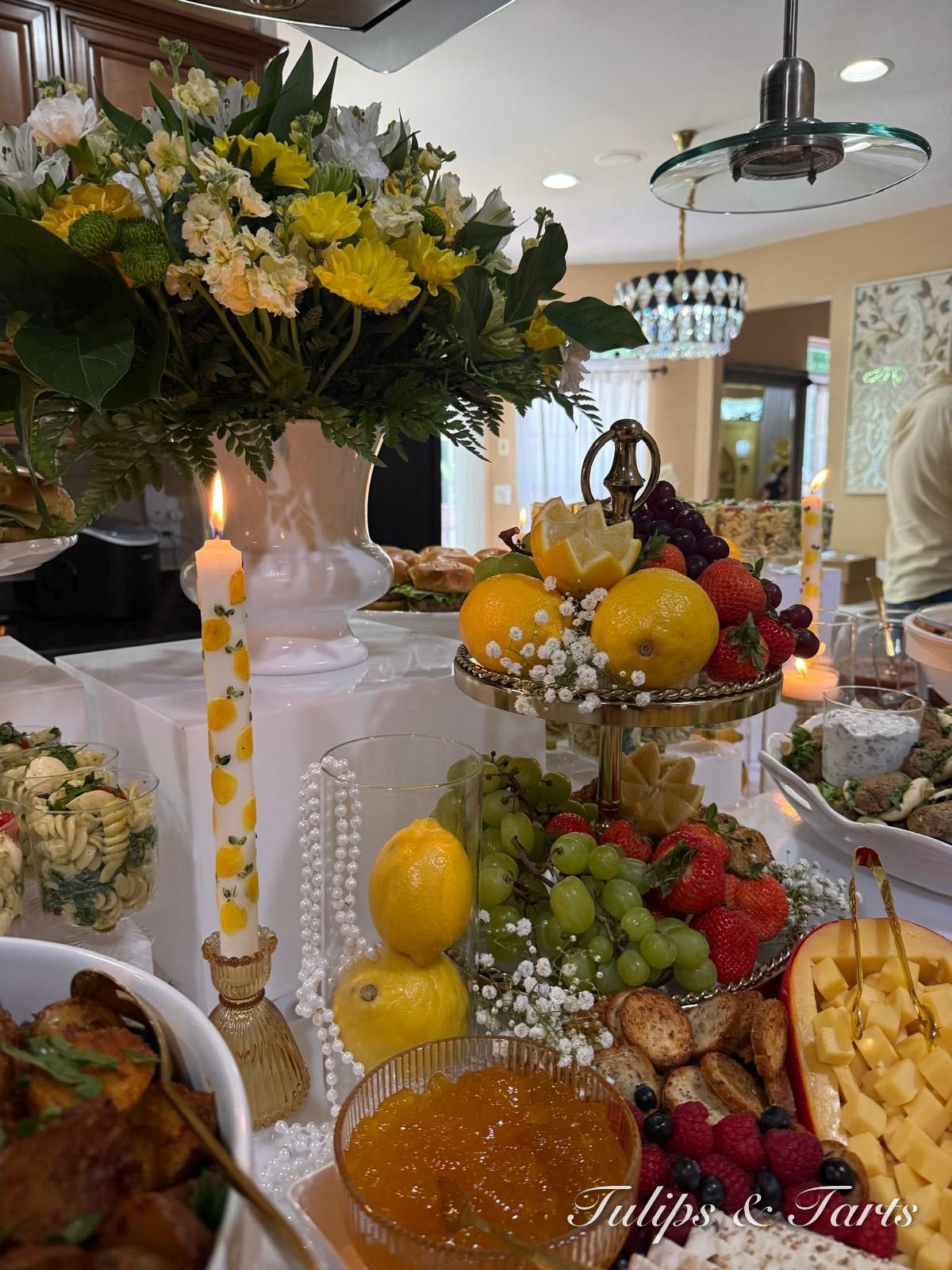 Elegant grazing table styled with fresh florals and fruit