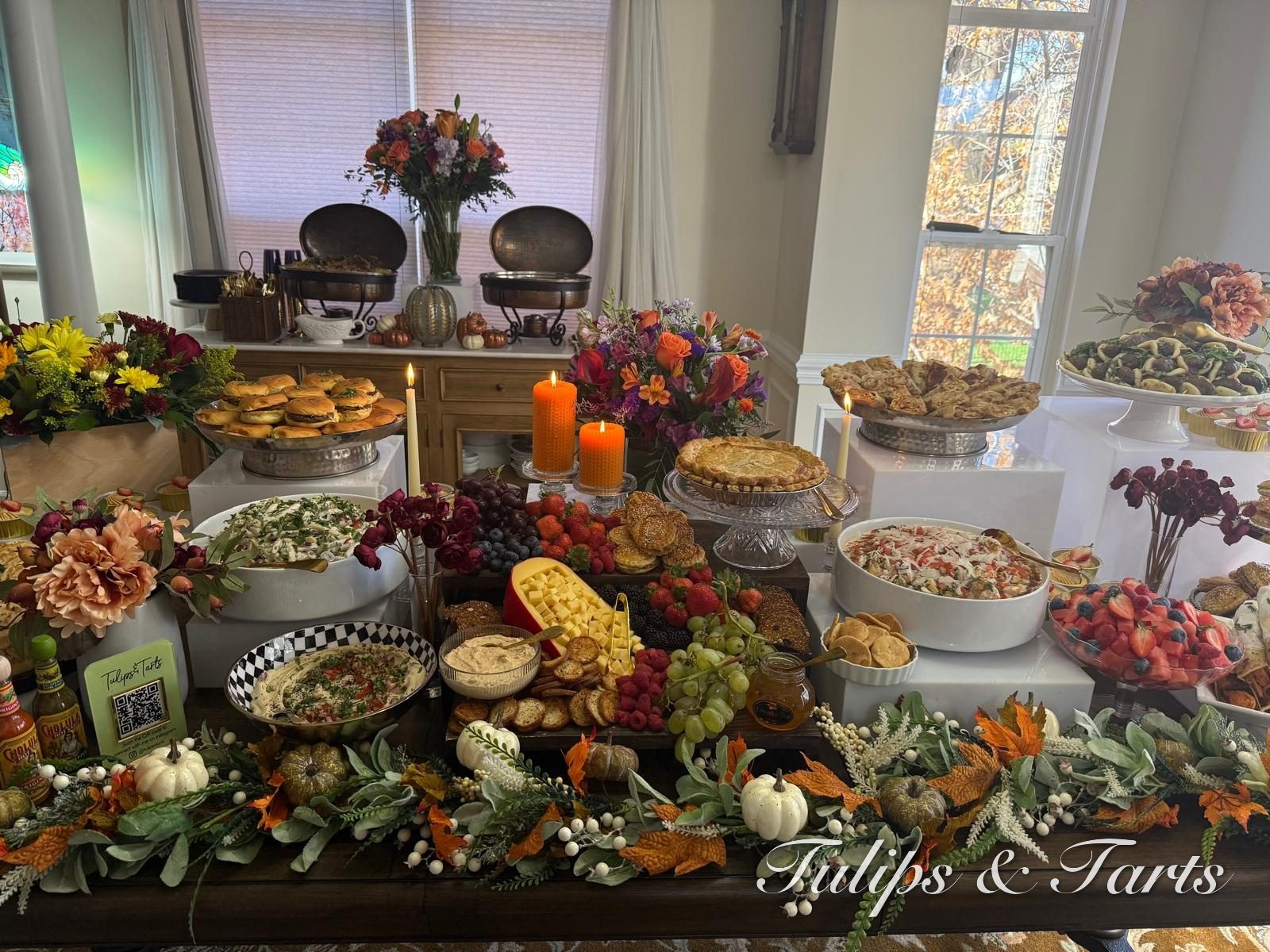 Lush autumn-themed grazing table with florals and charcuterie