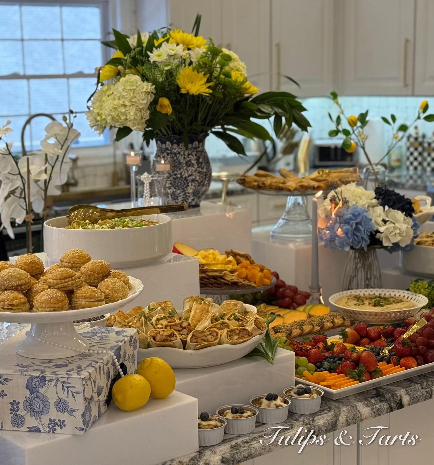 Elegant grazing table with blue-and-white china and yellow florals