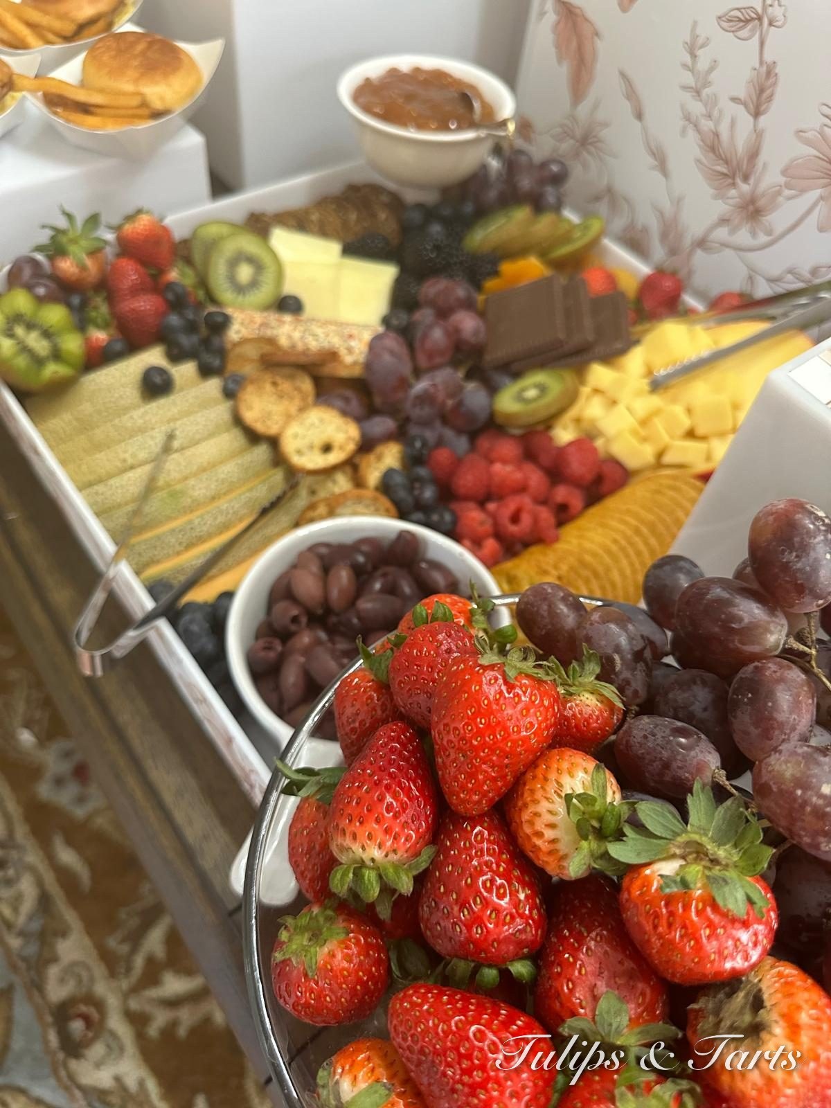 Fresh fruit and cheese tower with strawberries and grapes
